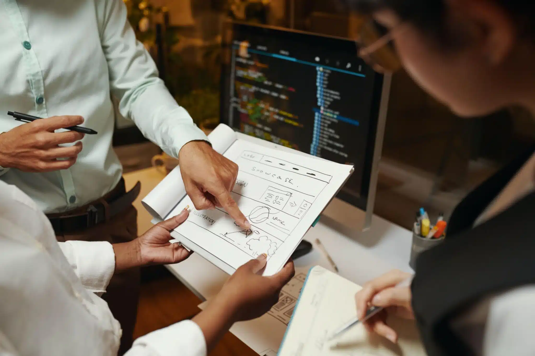 Choosing the Right Web Design Agency for Your Business Business owners reviewing a website project and discussing web design strategy with a marketing team.