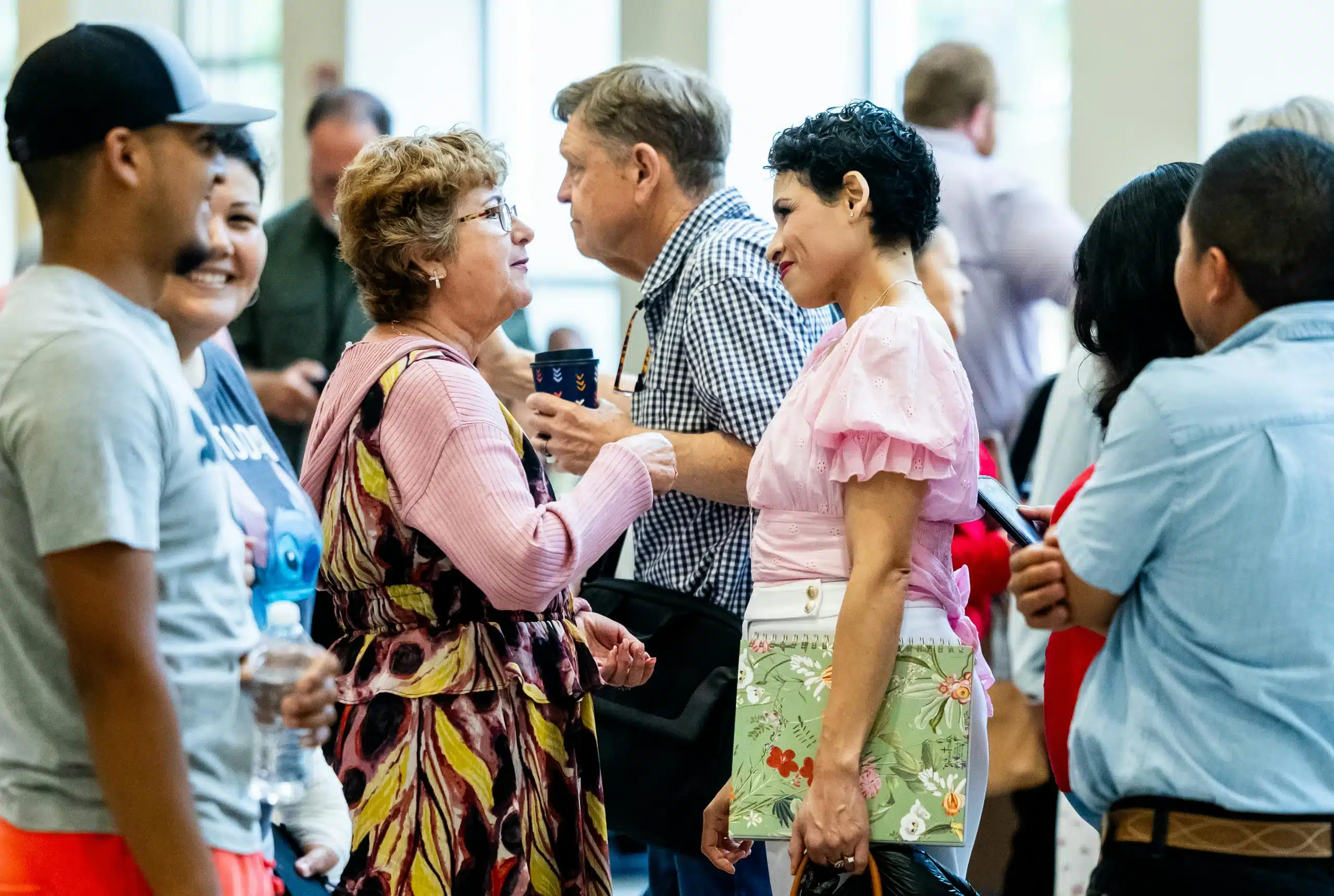 Diverse group of people socializing indoors, representing authentic community connection in Hispanic marketing Diverse group of people socializing indoors, representing authentic community connection in Hispanic marketing