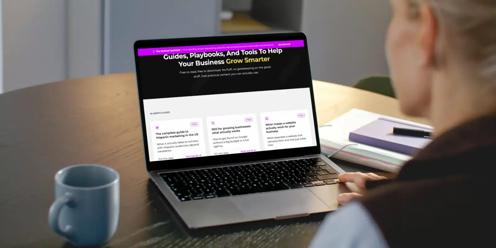 MoDuet Launches Free Resource Library to Help Small Businesses Master Digital Marketing in English and Spanish A marketing professional reviewing MoDuet's free resource library on a laptop, featuring guides and tools for small businesses in English and Spanish.
